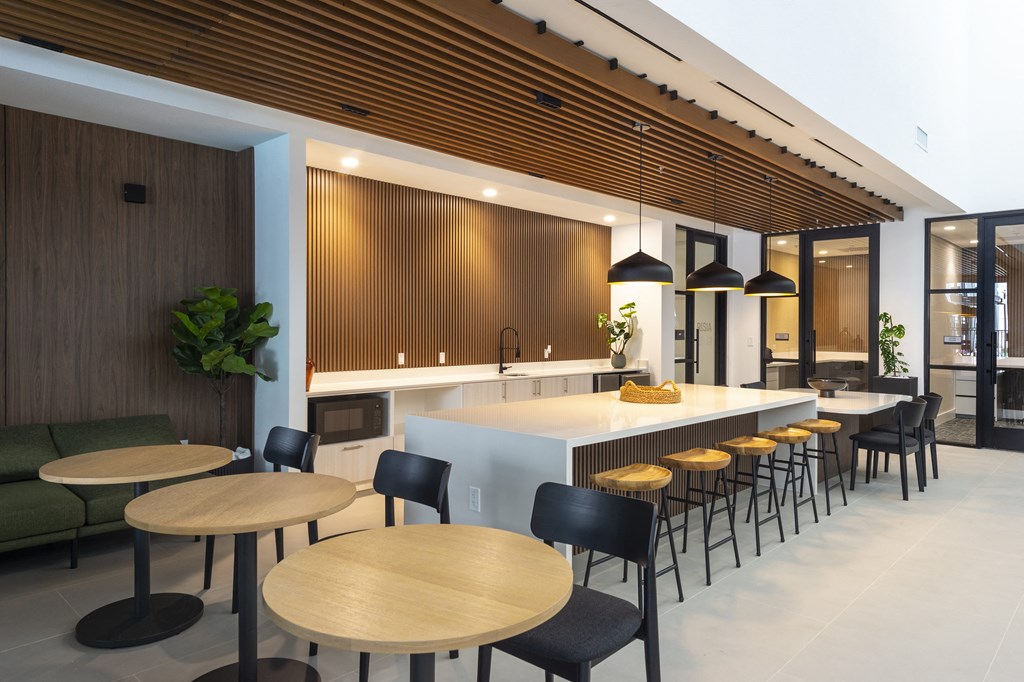 a kitchen and dining area with wooden tables and chairs
