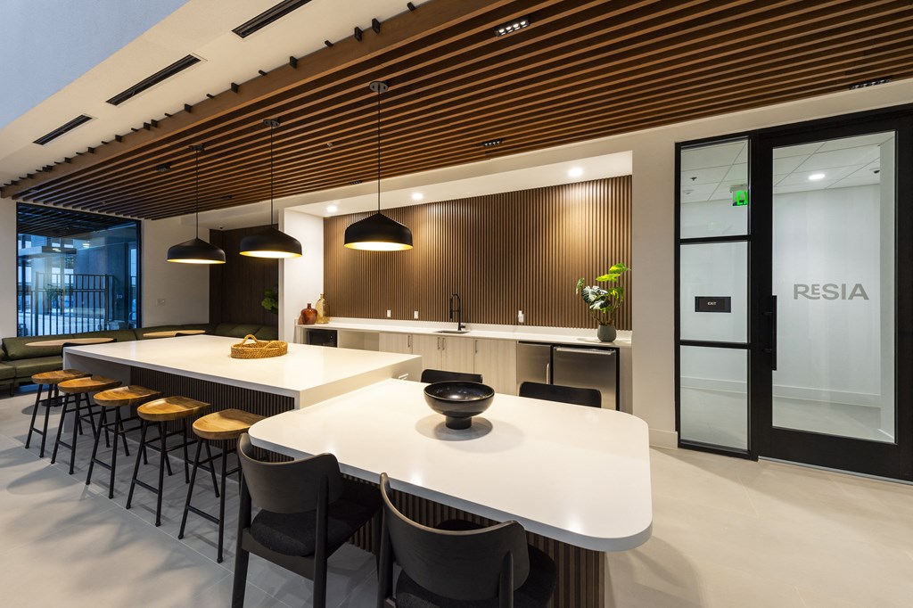 a large kitchen with a white table and chairs