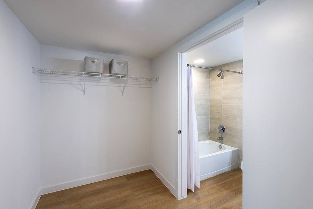 a bathroom with a shower and a bath tub in it