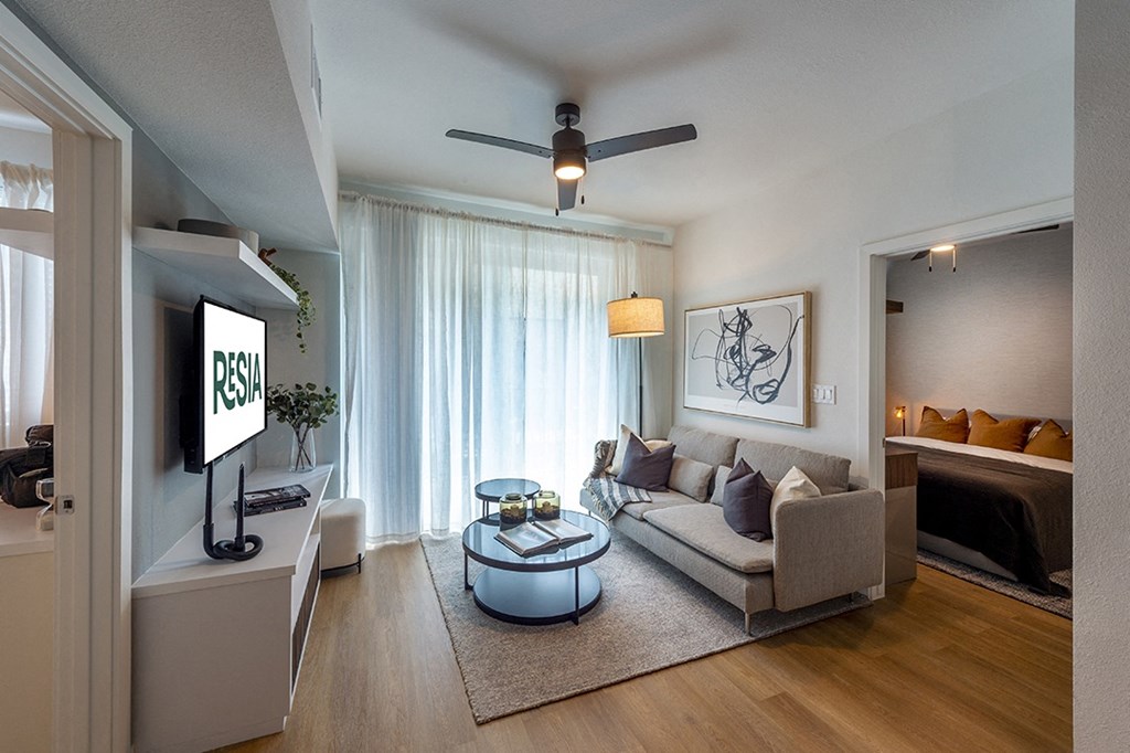 a living room with a couch and a bed and a window