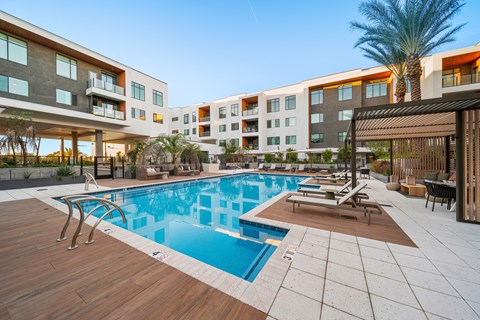 A modern building with a pool in the foreground.