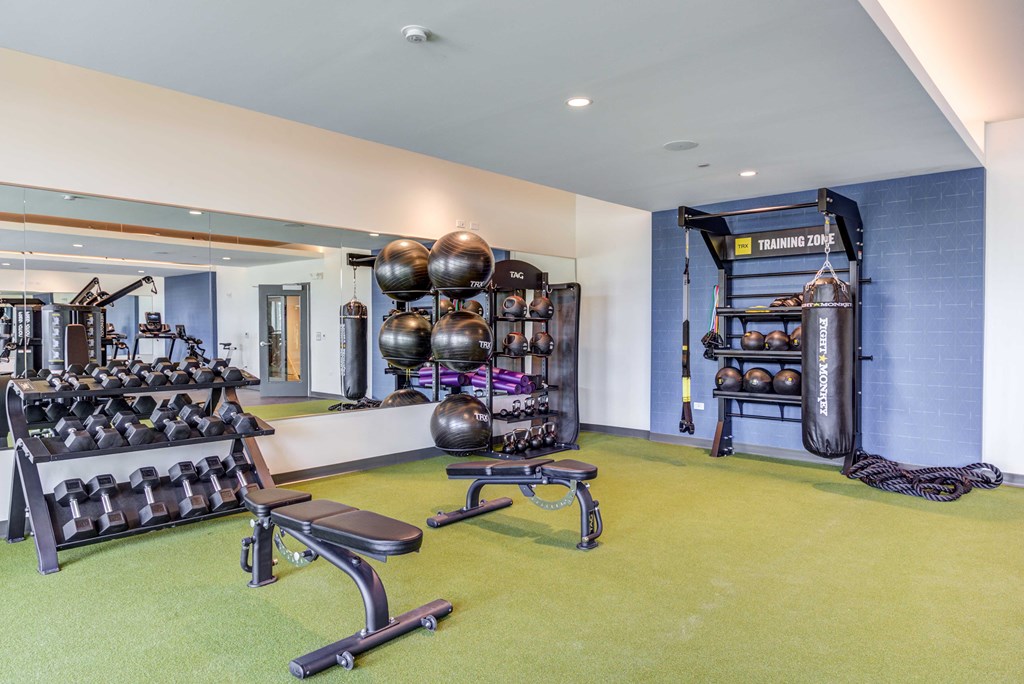 a workout room with weights and other exercise equipment