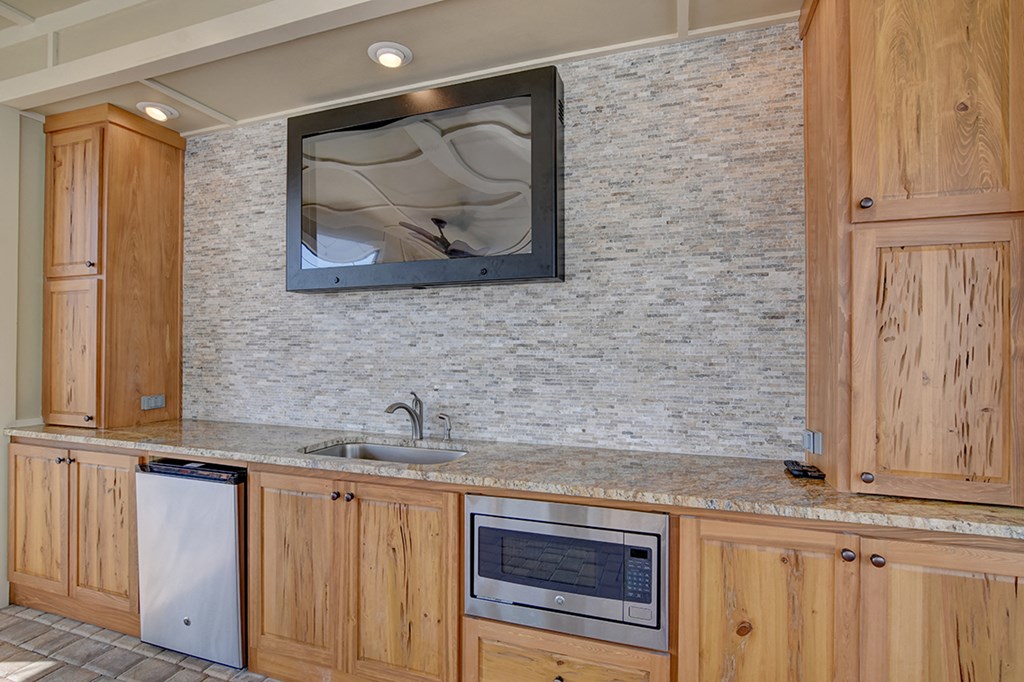 A kitchen with wooden cabinets and a granite countertop.