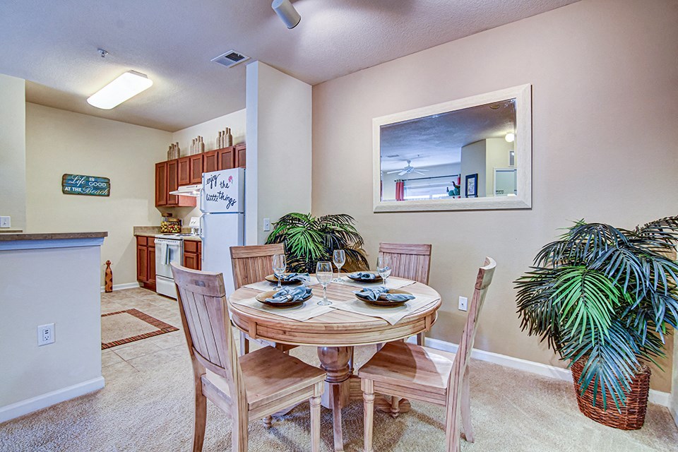 A dining room with a table set for four.