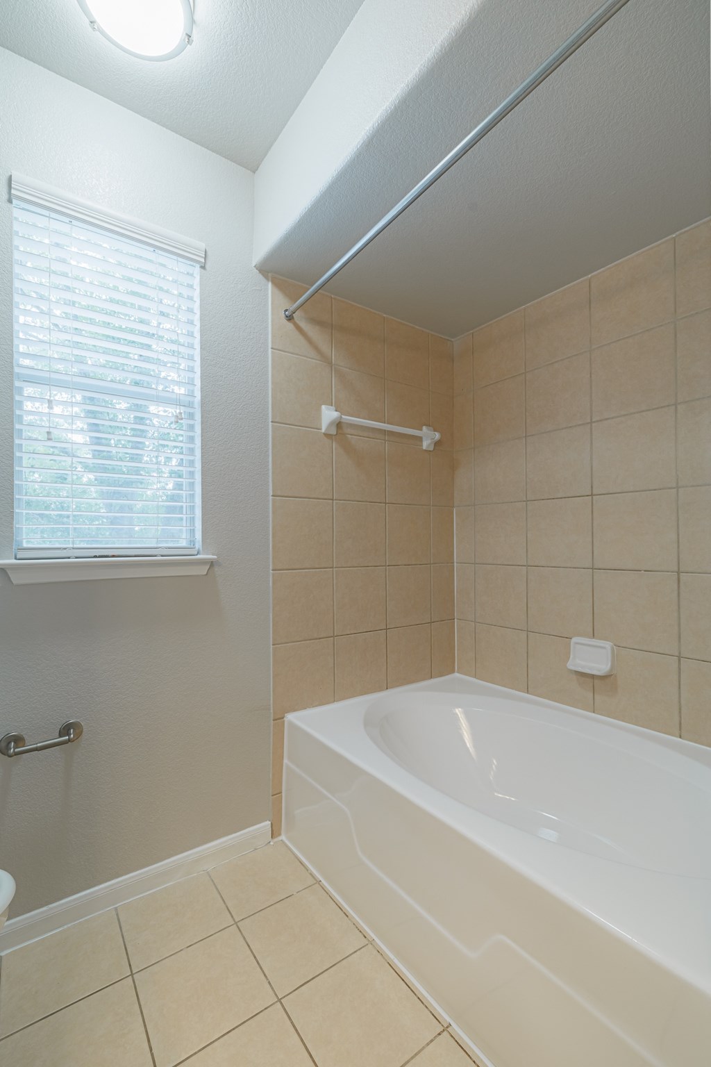 an empty bathroom with a tub and a window
