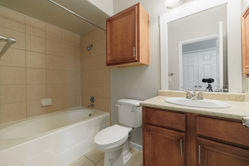 a bathroom with a sink toilet and a bath tub