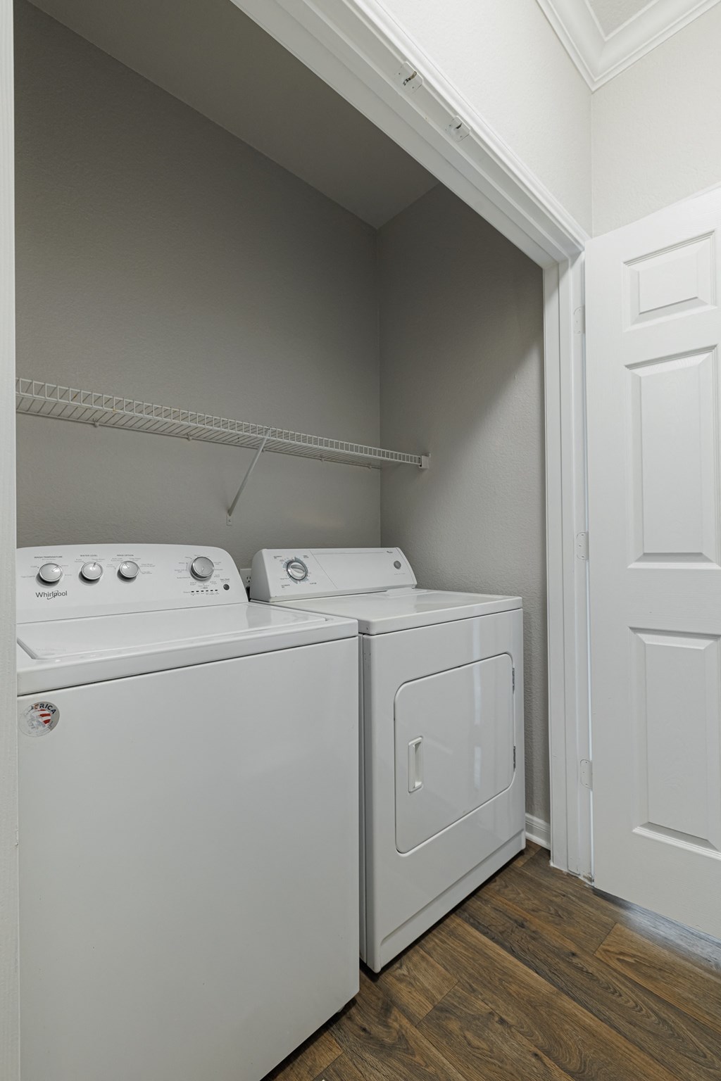 a white washer and dryer in a room with a white door