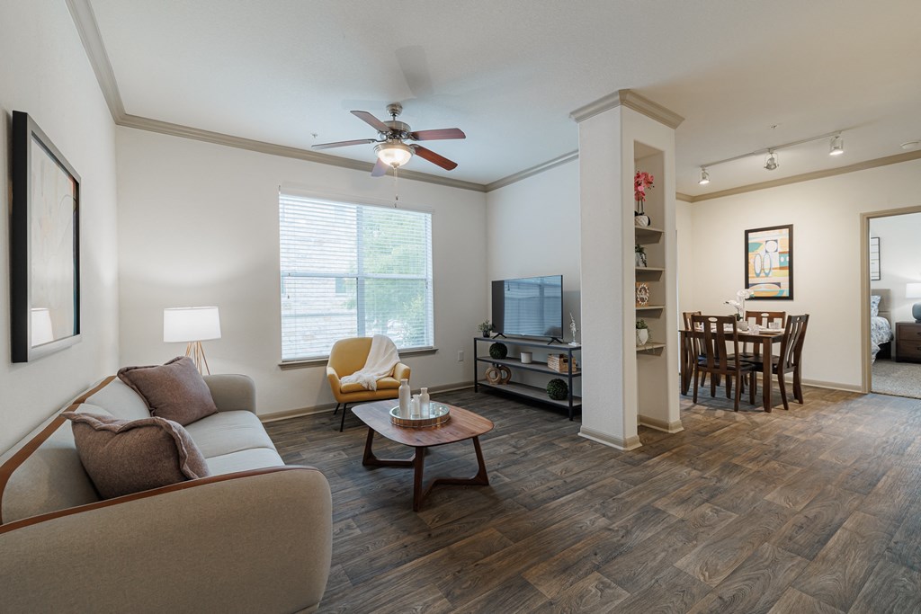 a living room with a couch and a ceiling fan