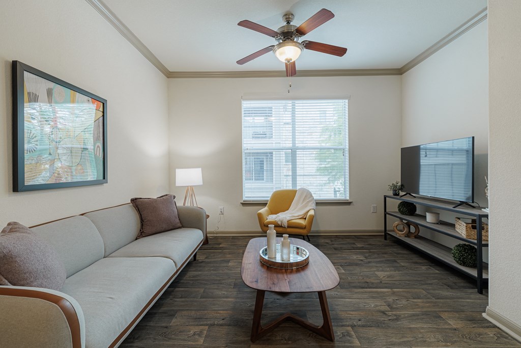 a living room with a ceiling fan and a couch