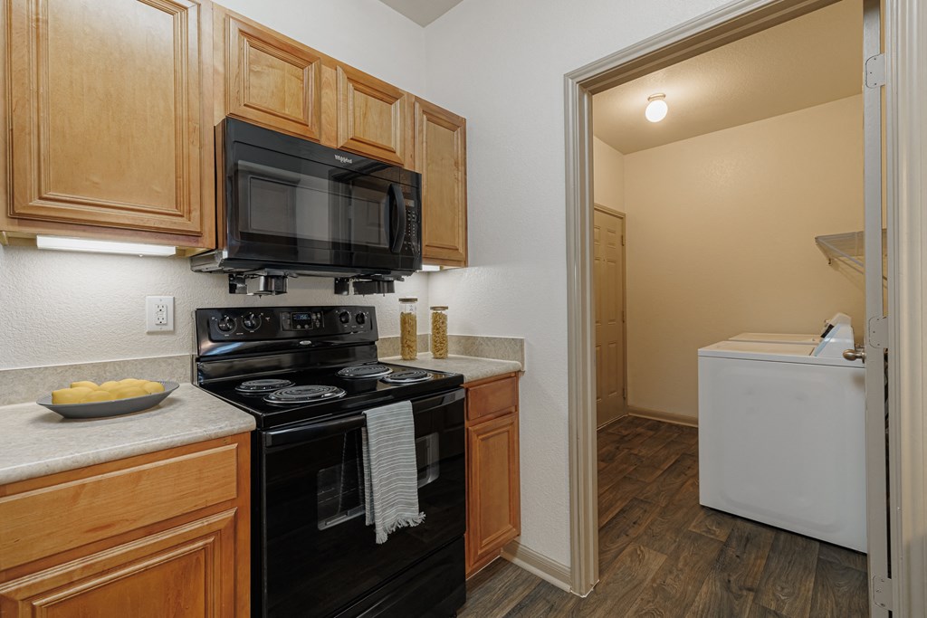 a kitchen with a stove and a microwave and a refrigerator