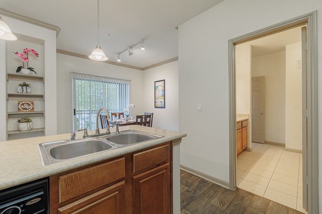 a kitchen with a sink and a doorway to a dining room