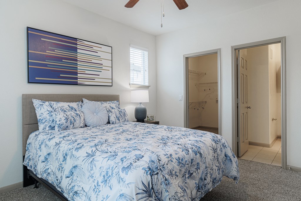 a blue and white bedroom with a bed and a closet