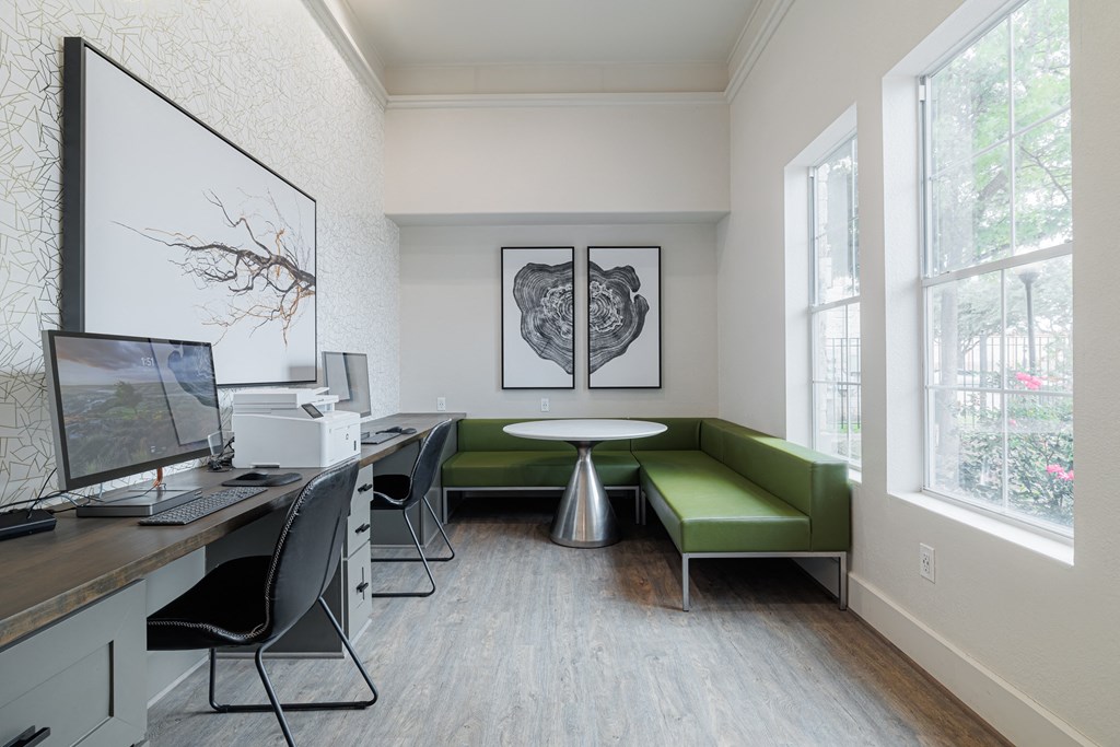 a room with a computer desk and a green couch
