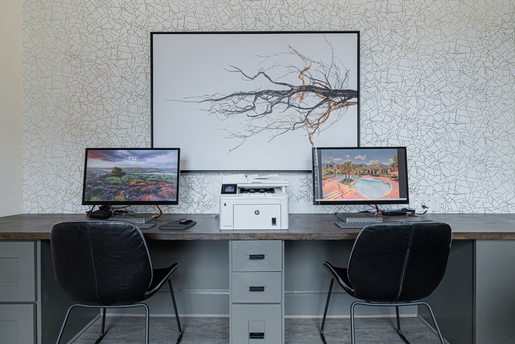 a desk with two computer monitors on top of it