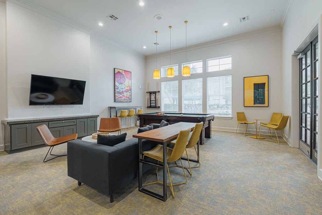 a lounge area with a table and chairs and a television