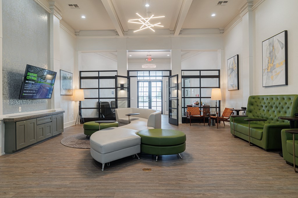 a living room with couches and chairs and a tv