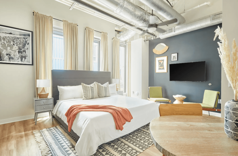 a bedroom with a bed and a tv