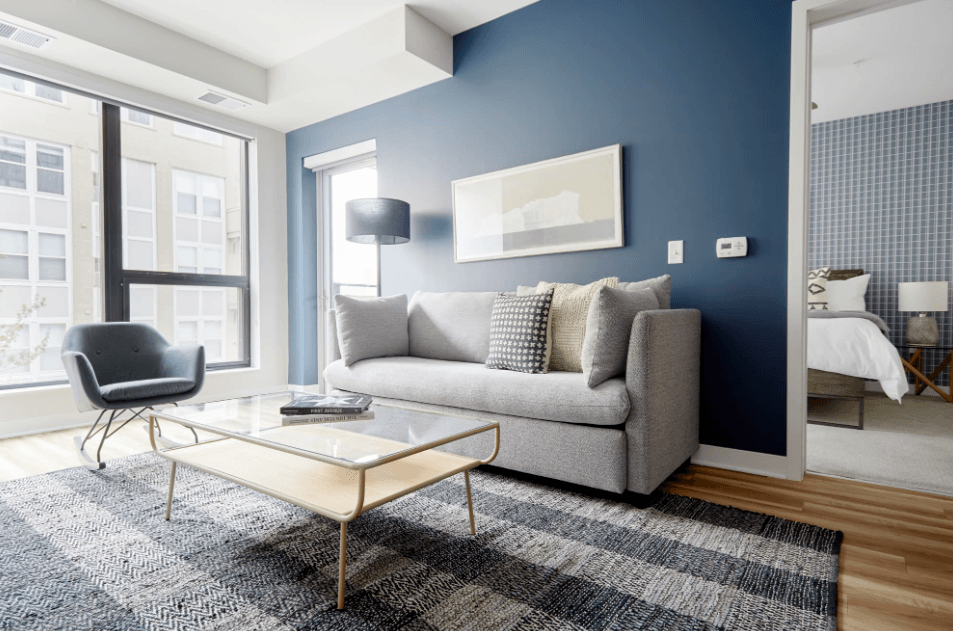 a living room with blue walls and a couch and a coffee table