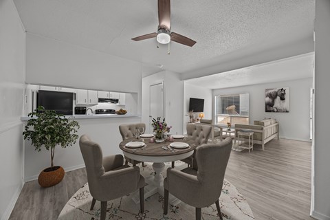 A dining room with a round table and chairs.