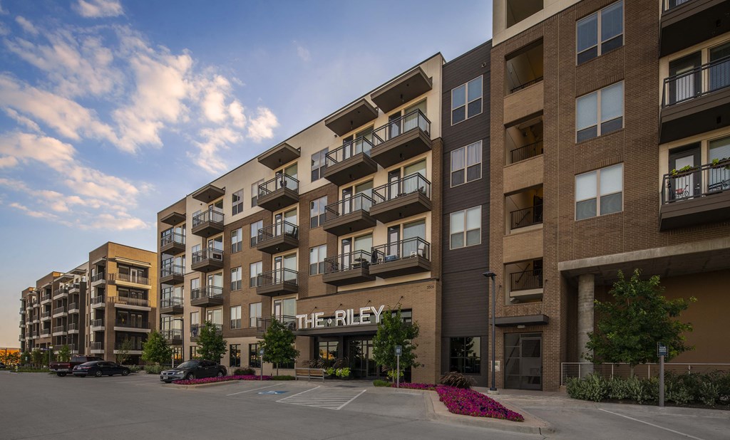 a rendering of a large apartment building with balconies and a sign that reads the ride