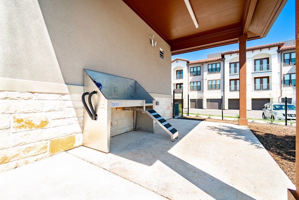 A concrete skateboard ramp is in the foreground of a sunny day.