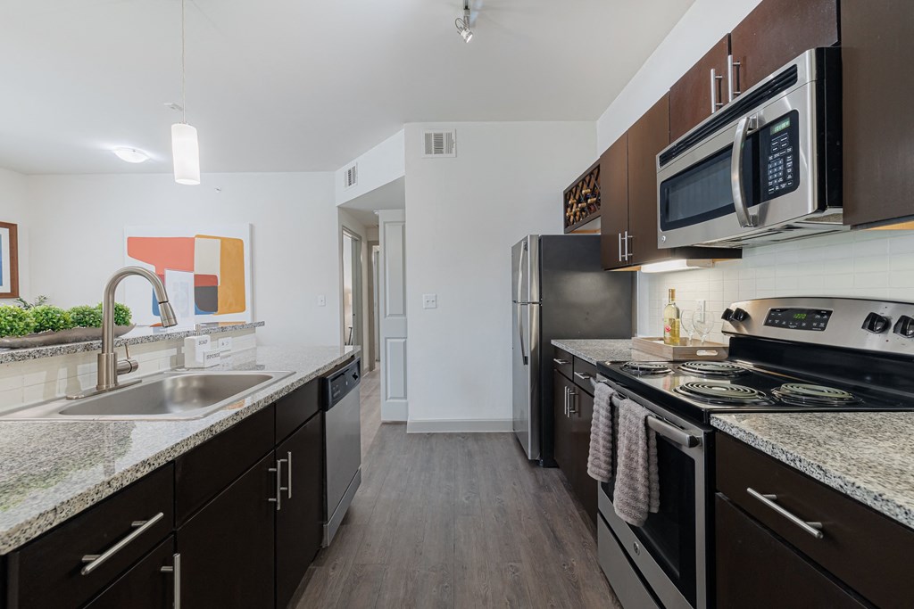 a kitchen with stainless steel appliances and granite counter tops and