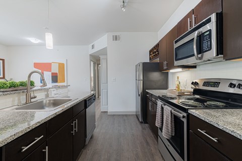 a kitchen with stainless steel appliances and granite counter tops and