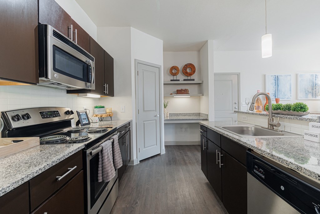 a kitchen with granite counter tops and stainless steel appliances