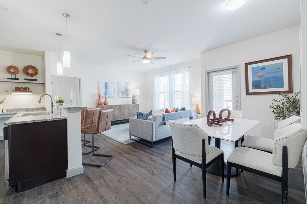 a living room with a dining room table and a kitchen