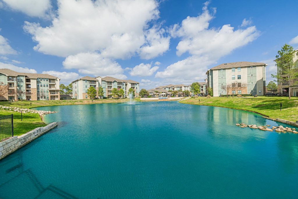 a large lake with apartments in the background