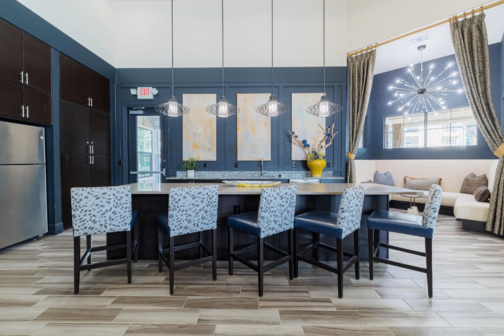 a dining room with a table and chairs and a kitchen