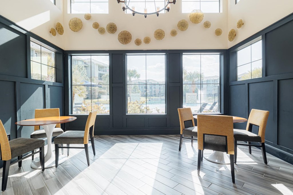 a dining room with tables and chairs and a large window