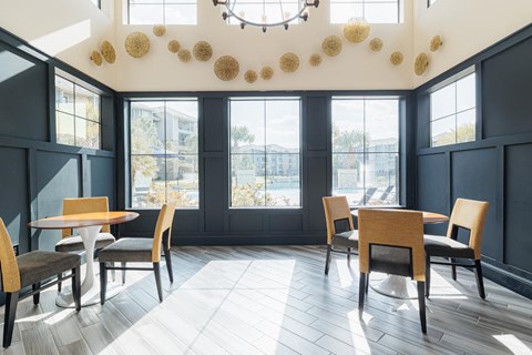 a dining room with tables and chairs and a large window