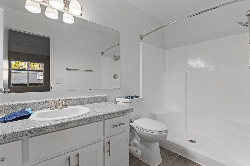 A white bathroom with a sink, toilet, and bathtub.