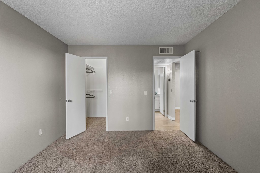A room with carpeted floor and white walls.