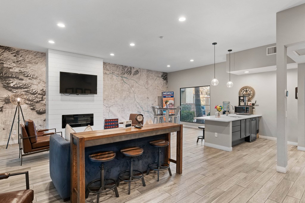 A modern living room with a fireplace and a bar area.