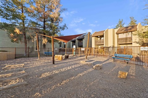 A playground with a swing set and a slide.