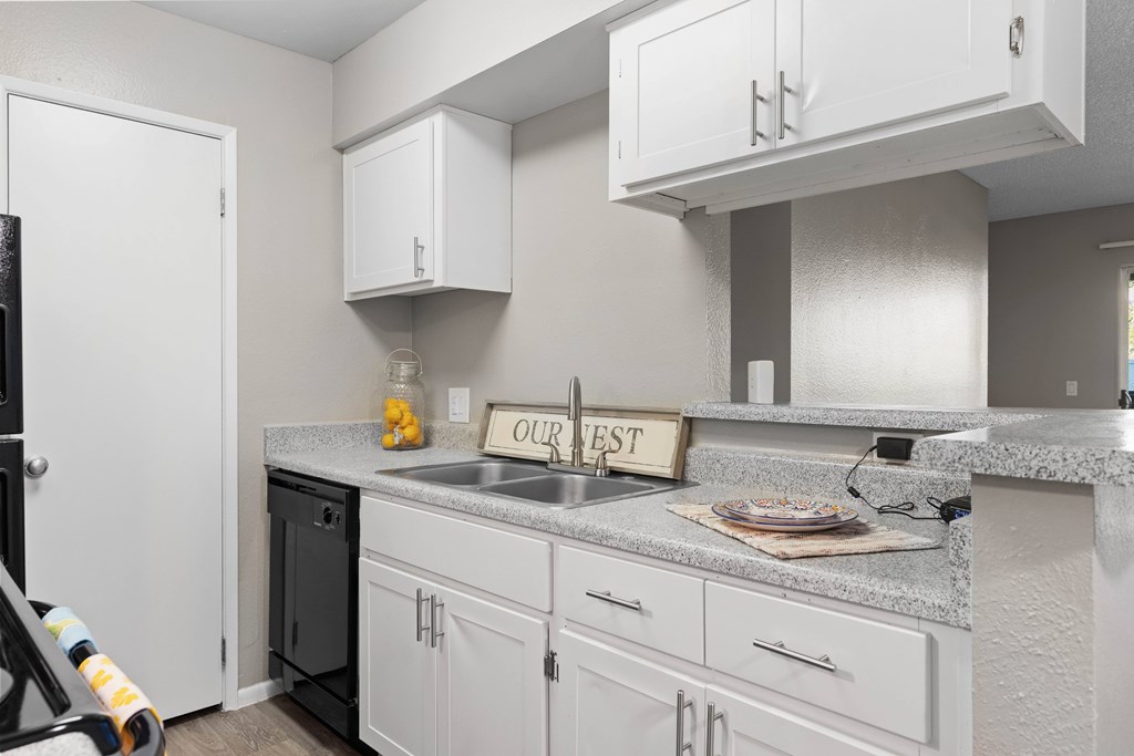 A kitchen with a sign that says "our nest".