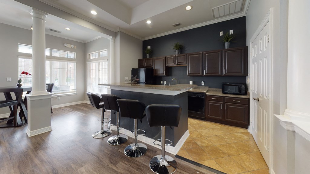 a kitchen with a bar and stools