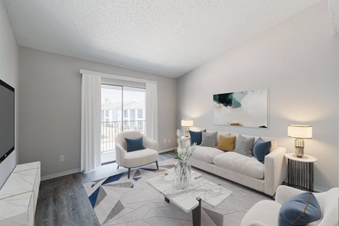 A living room with a white couch, a coffee table, and a painting on the wall.