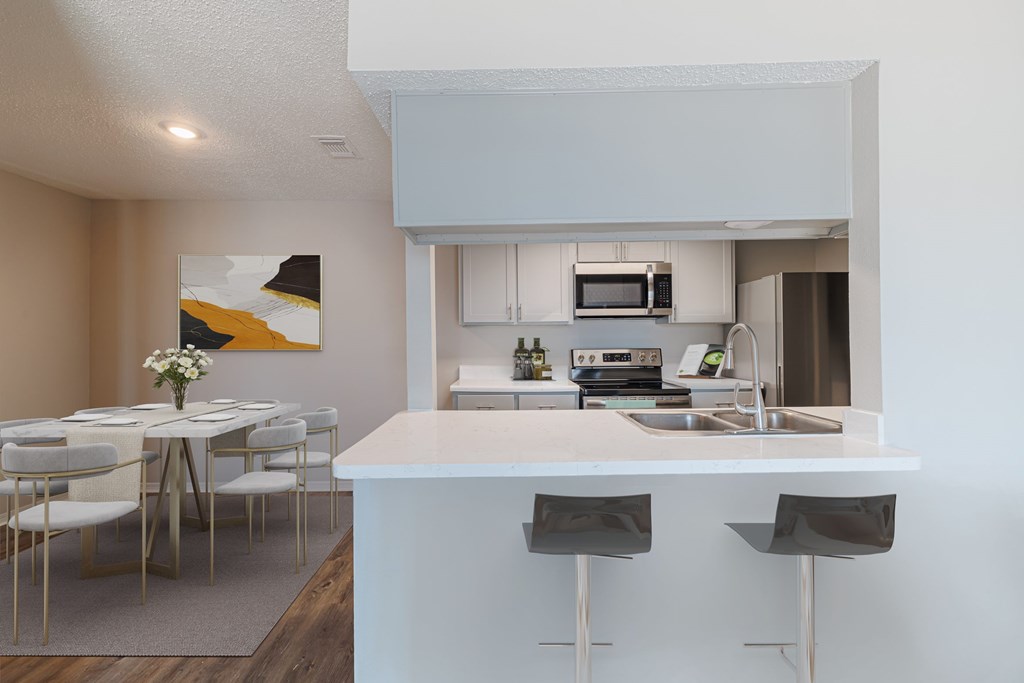 A modern kitchen with a dining table and chairs.
