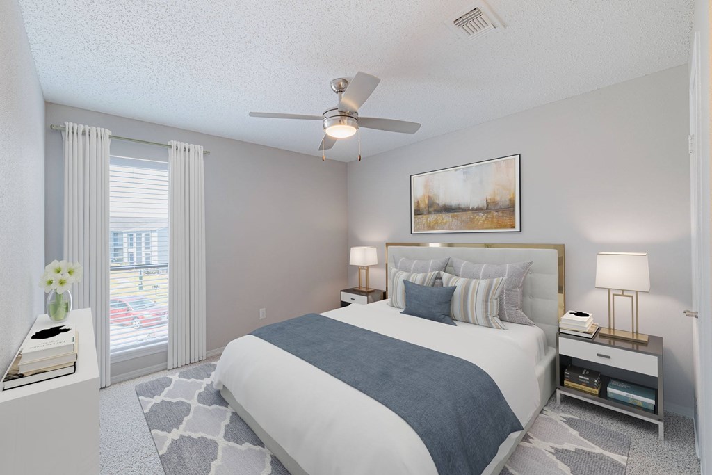 A bedroom with a large bed and a painting on the wall.