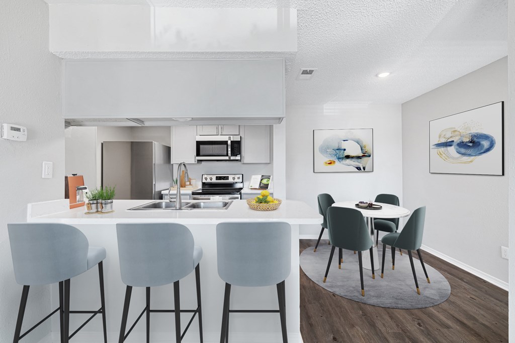 A modern kitchen with a dining table and chairs.