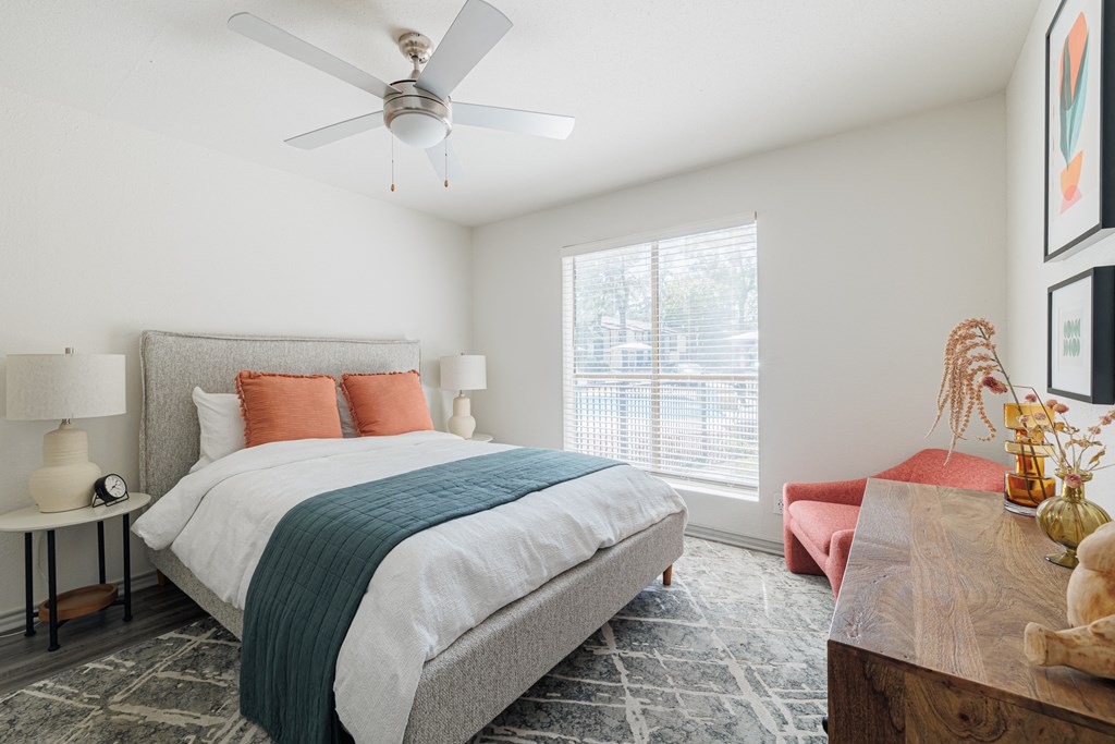 a bedroom with a bed and a ceiling fan