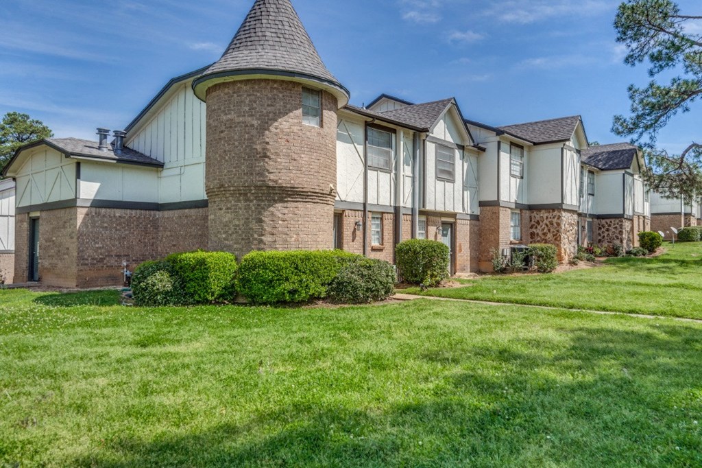 a large house with a yard in front of it
