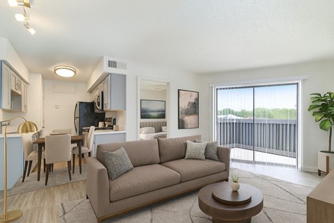 A living room with a couch, chairs, and a coffee table.