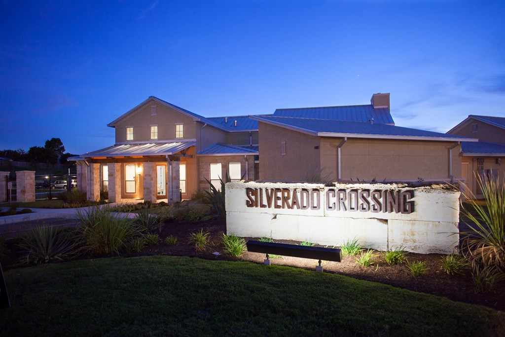 A sign that says Silverado Crossing in front of a house.