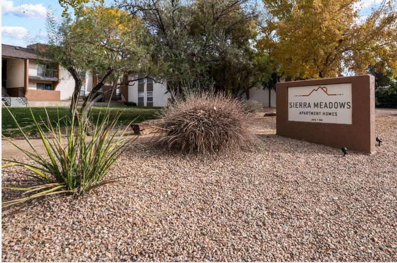 a sign for serene meadows in front of a building