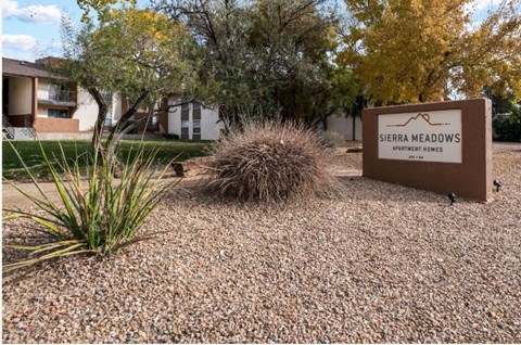 a sign for serene meadows in front of a building