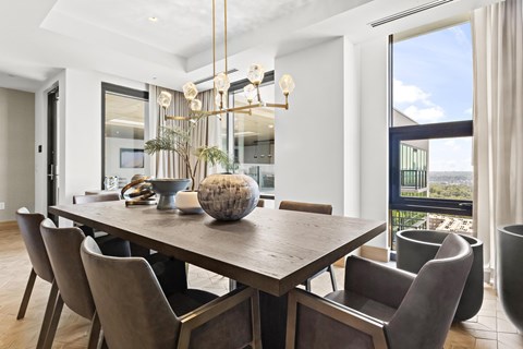 A modern dining room with a large table and chairs.